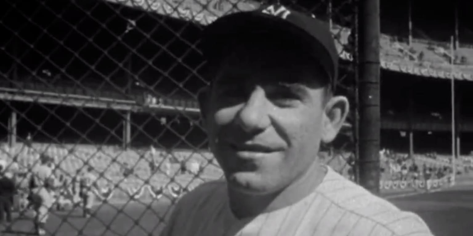 Catcher Yogi Berra (8) has jumped into the arms of pitcher Don