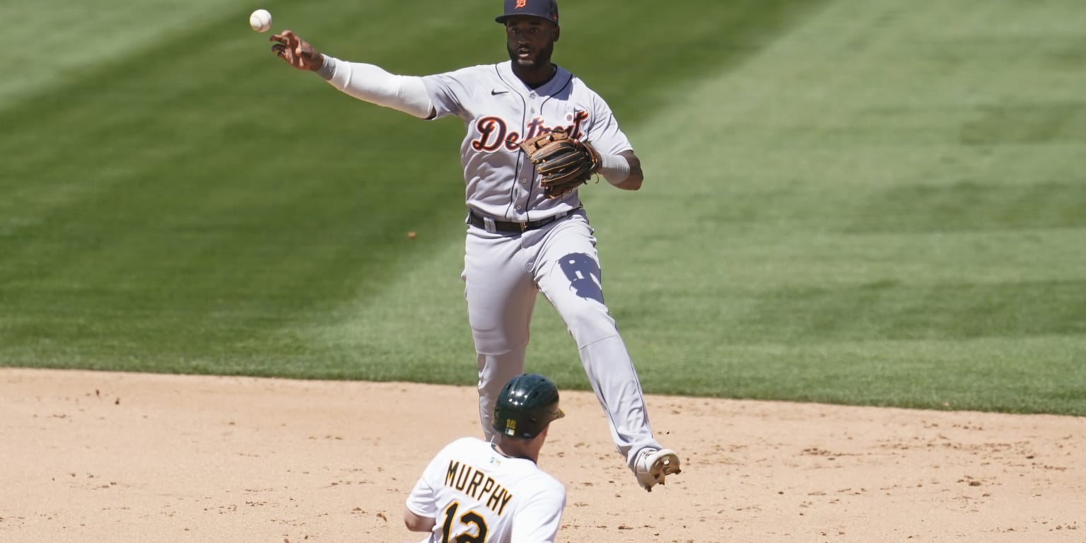 Detroit Tigers shortstop Niko Goodrum throws to first during a