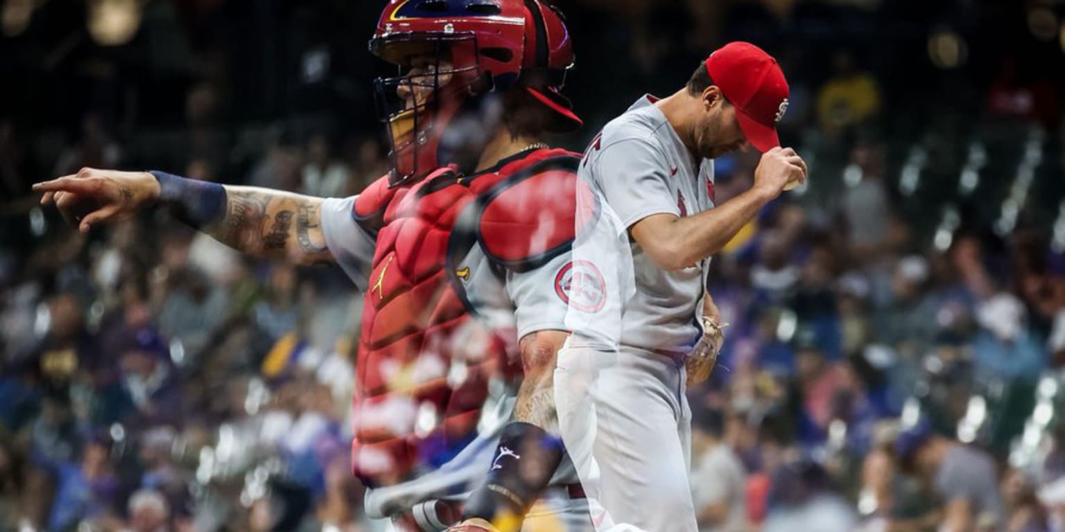 St. Louis Cardinals starting pitcher Adam Wainwright (R) bumps fists with  catcher Yadier Molina as they walk in from the bullpen before a game  against the Washington Nationals at Busch Stadium in