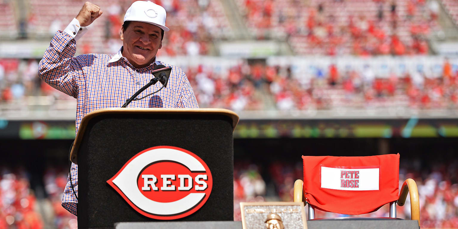 Former Cincinnati Reds manager Pete Rose hits a softball during