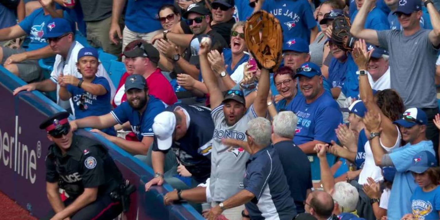 Blue Jays fan uses his giant glove to pull foul ball into its