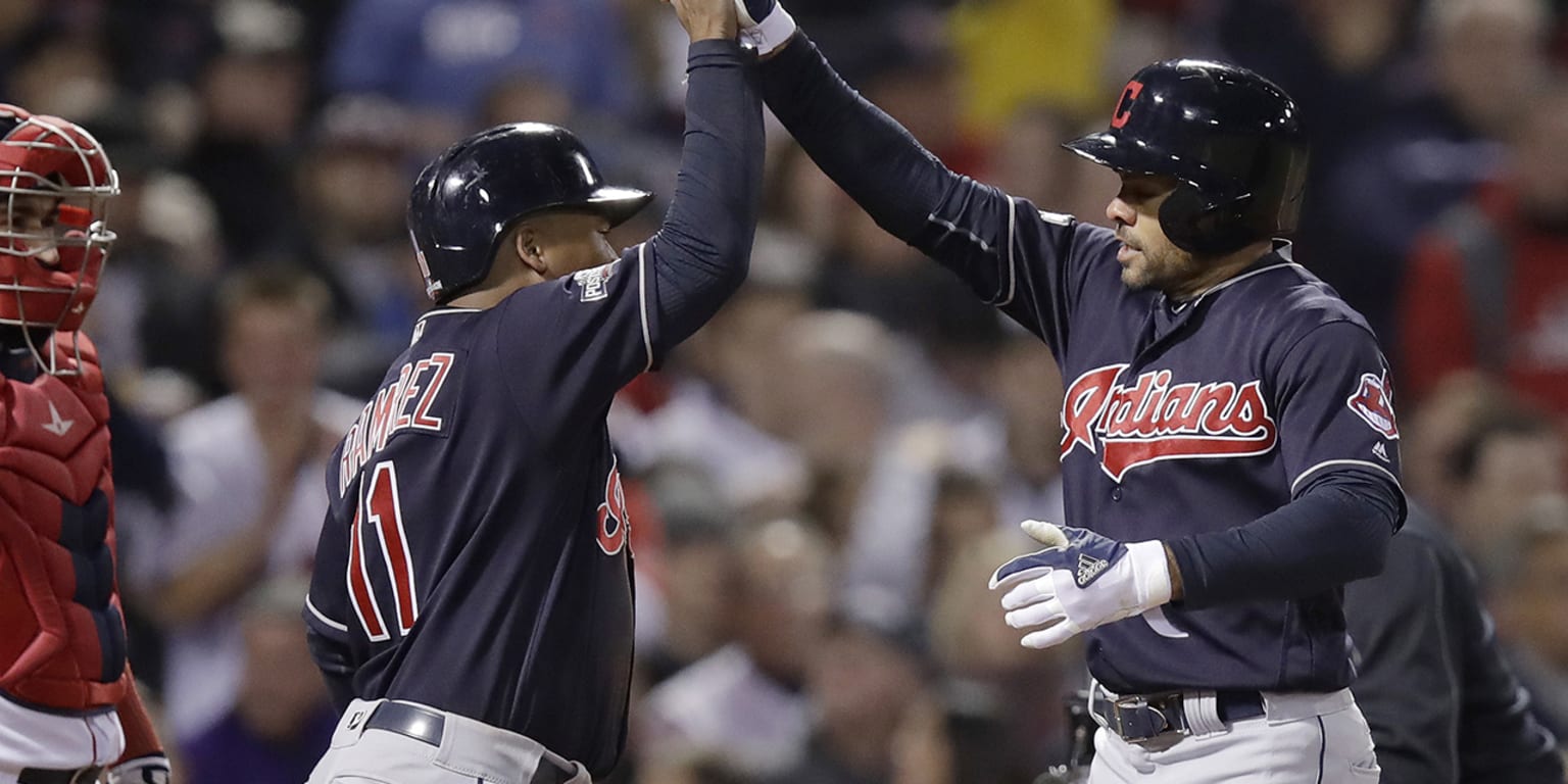 Cleveland Indians' Coco Crisp, right, watches his two-run home run off Boston  Red Sox relief pitcher Drew Pomeranz during the sixth inning in Game 3 of  baseball's American League Division Series, …