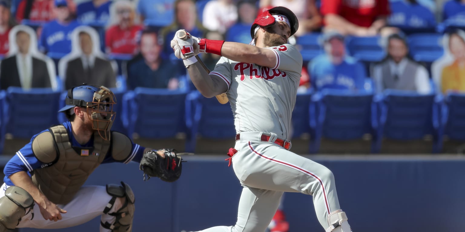 Bryce Harper and Jean Segura of the Philadelphia Phillies react