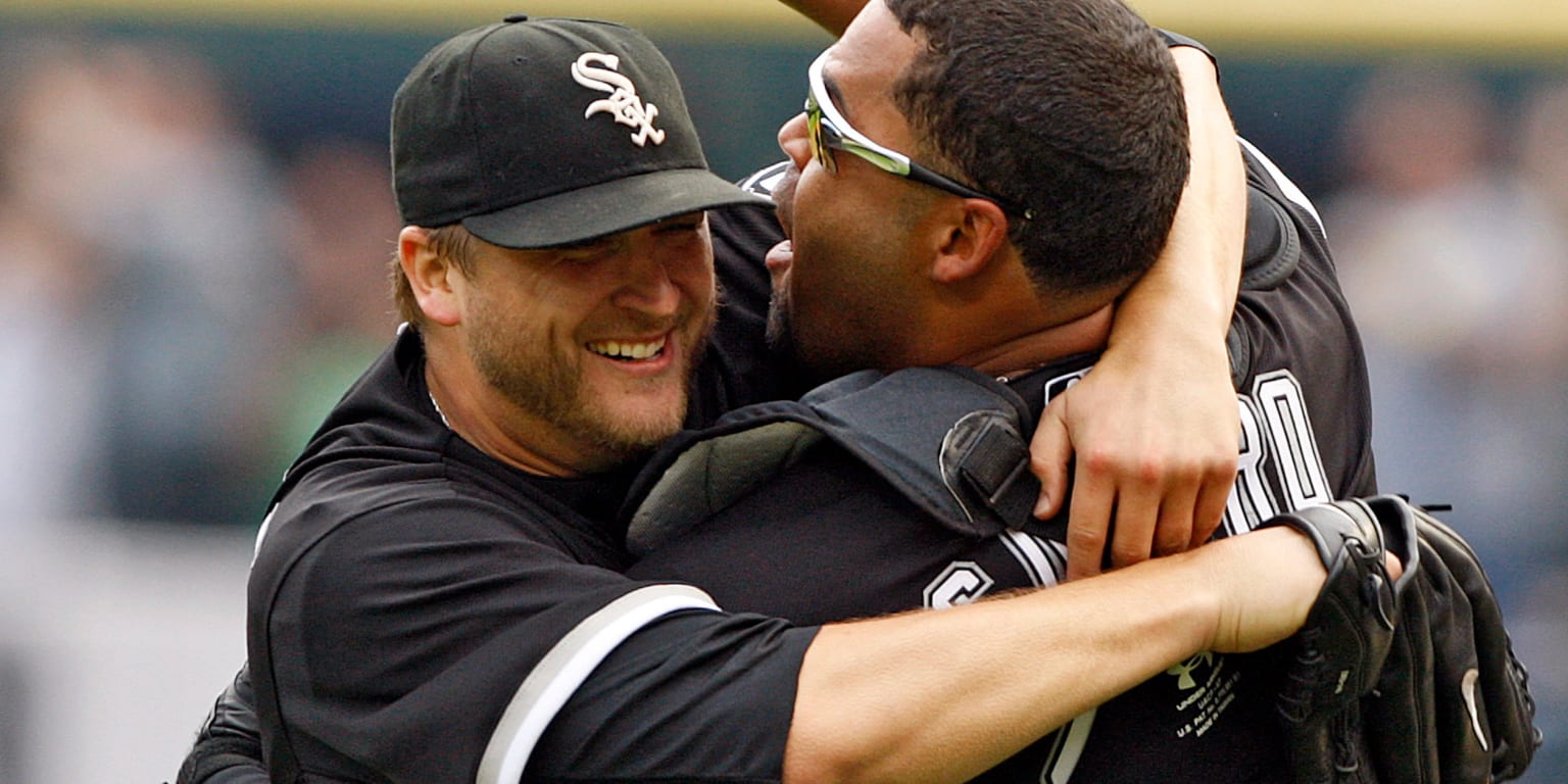 Chicago White Sox manager Ozzie Guillen, right, hugs right fielder