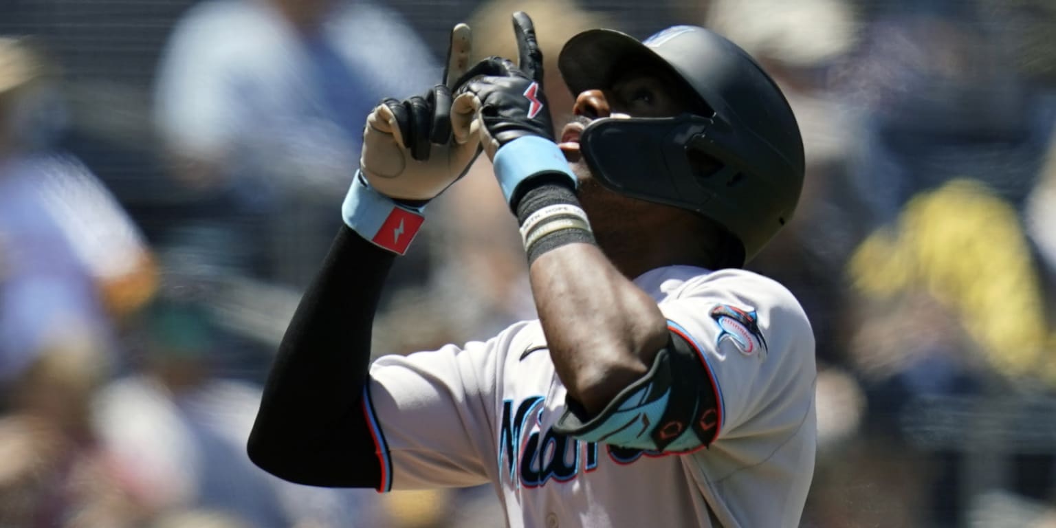 Miami Marlins' Lewis Brinson points to the sky as he nears home plate after  hitting a two run home run against the San Diego Padres in the eighth  inning of a baseball