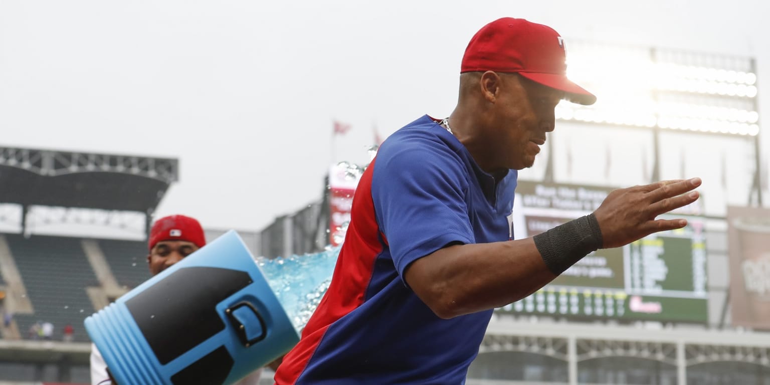 Retired Texas Rangers player Adrian Beltre, left, is presented with a gift  by shortstop Elvis Andrus from the team during a jersey retirement ceremony  for him before the second baseball game of