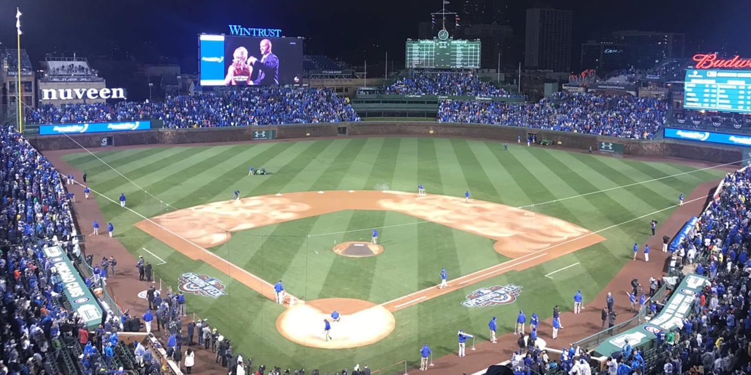 Chicago Cubs' David Ross holds the Commissioner's Trophy during