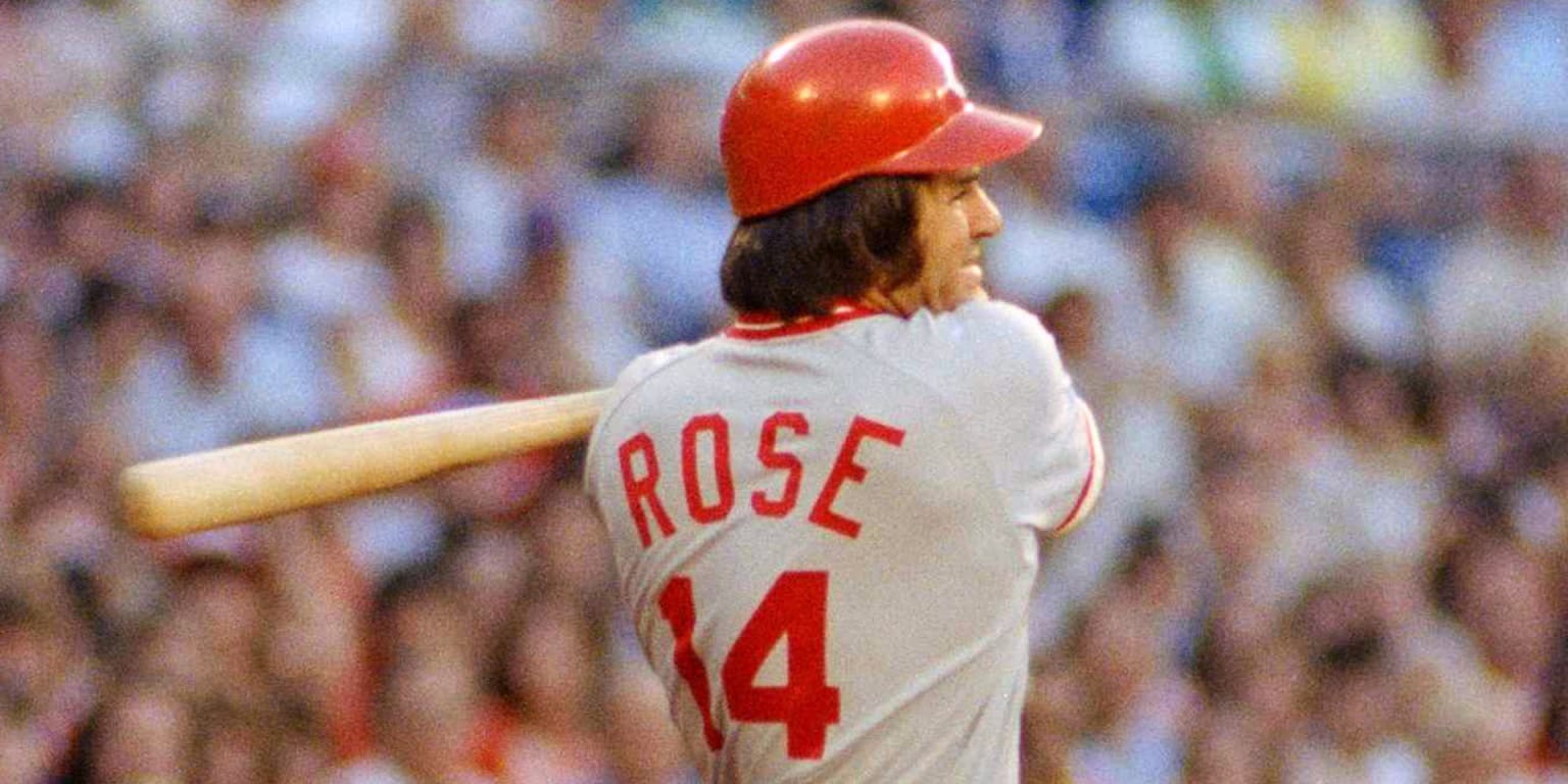 Former Cincinnati Reds manager Pete Rose hits a softball during