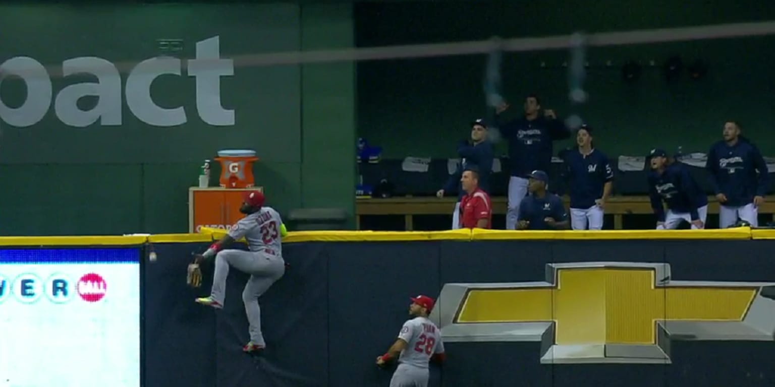 Marcell Ozuna climbs wall