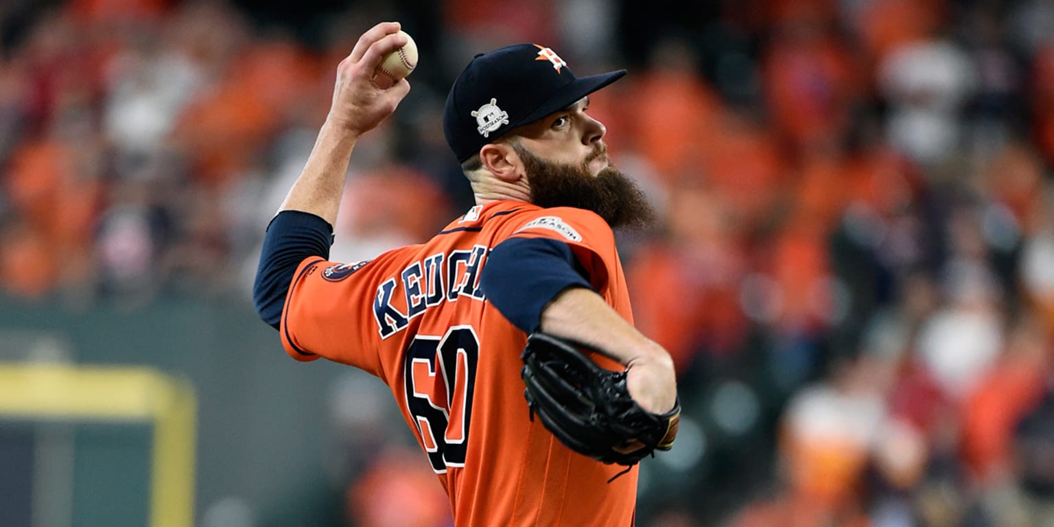 Dallas Keuchel of the Houston Astros tugs on his beard as he looks