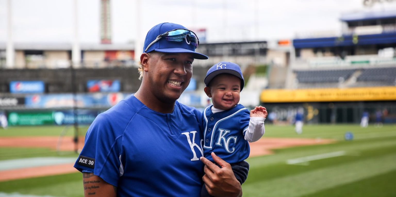 Good luck not smiling ear-to-ear at this photo of Salvador Perez and his  infant son on the field