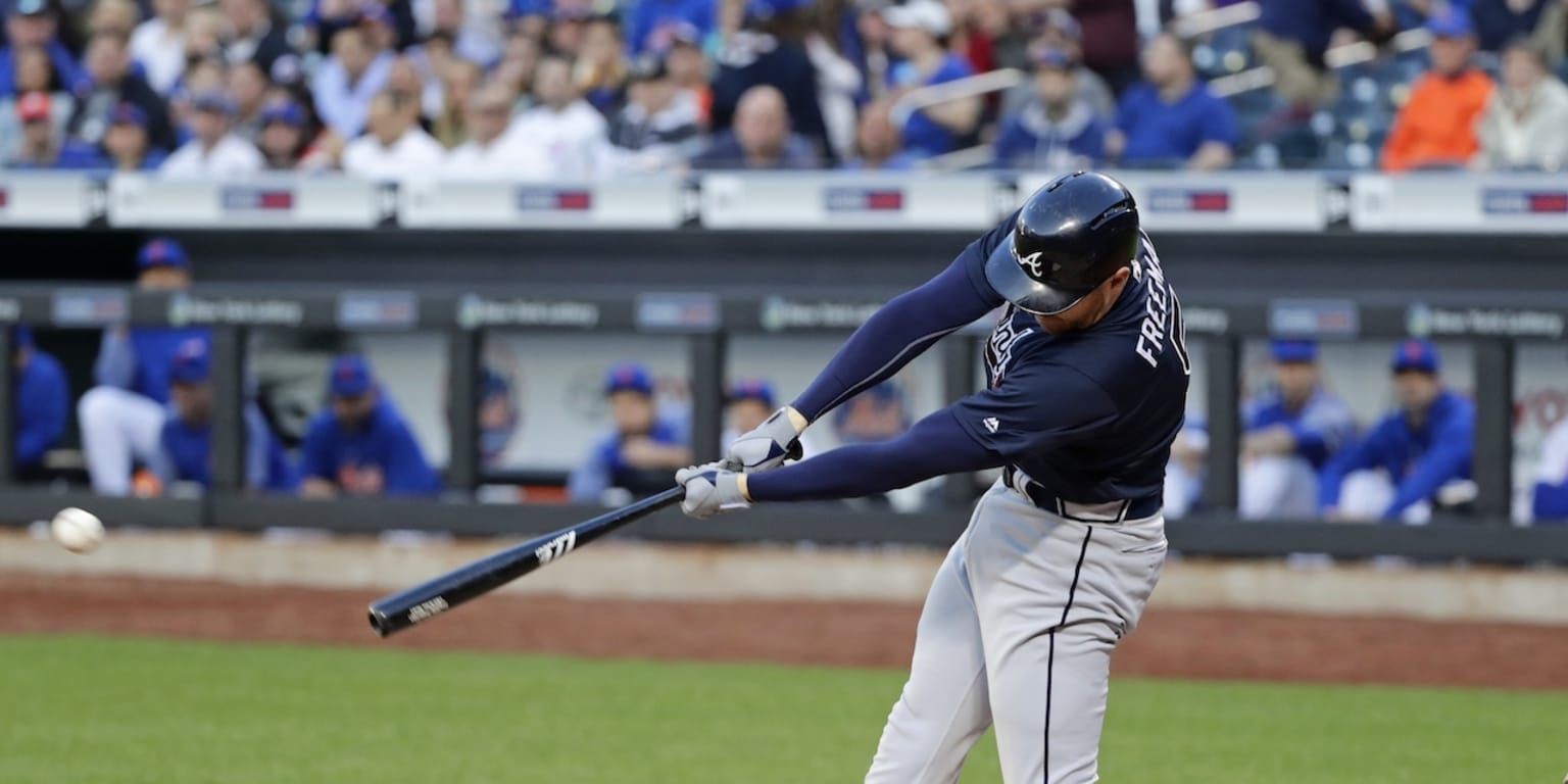 Atlanta Braves' Jason Heyward (R) gets a hug from teammate Freddie