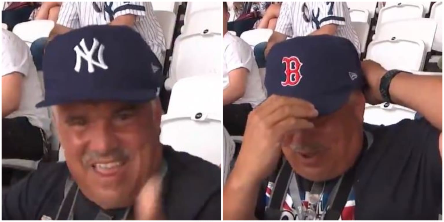 Fan wears Yankees and Red Sox hat in London