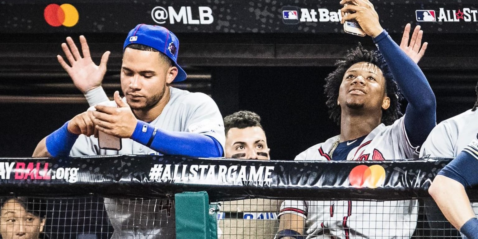AllStar Game players on phones in dugout