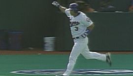 Montreal Expos' Vladimir Guerrero, right, swings for a homerun to  left-center in the sixth inning of the second game of a day-night  doubleheader against Cincinnati Reds at the Hiram Bithorn Stadium in