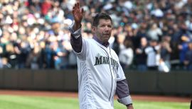 Seattle Mariners catcher Pat Borders watches from the dug out as San Diego  Padres take the field at Safeco field in Seattle, WA.