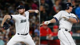 Seattle Mariners' Charlie Furbush, left, points out new socks as