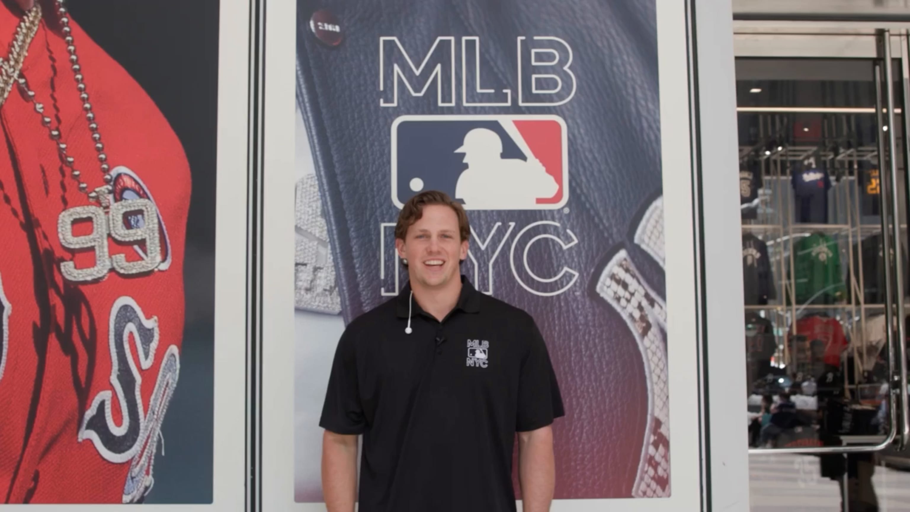 Adley Rutschman in a black polo shirt in front of the MLB Store