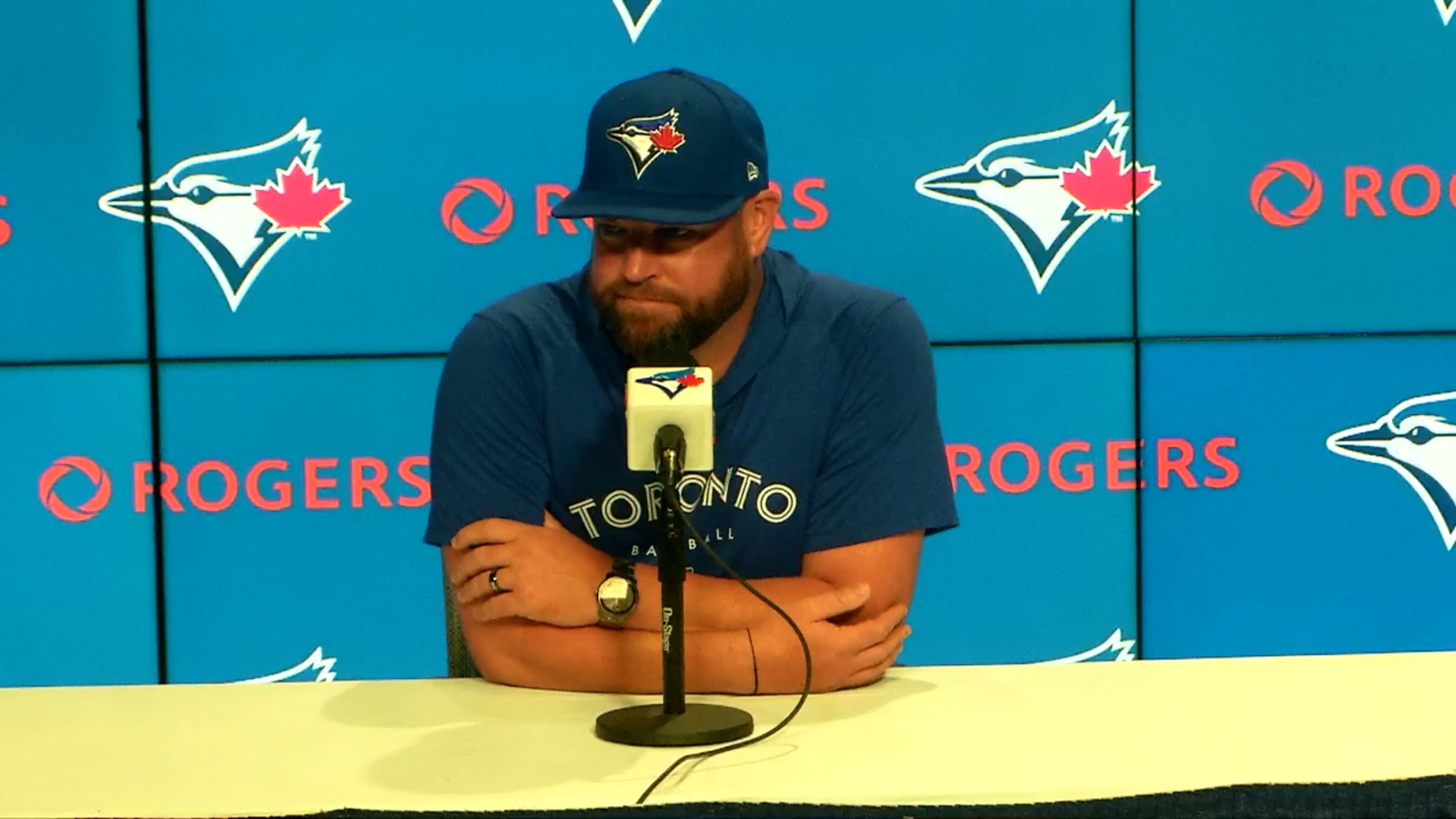 Toronto Blue Jays manager John Schneider, right, laughs as he