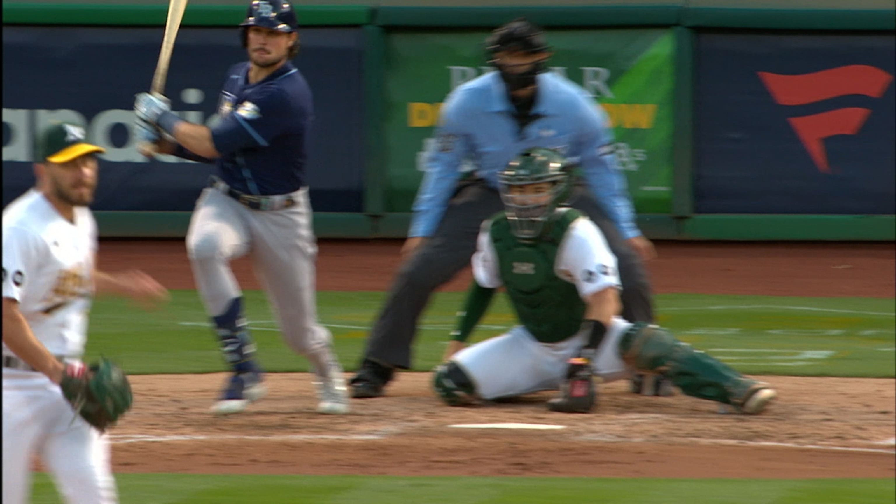 Tampa Bay Rays' Isaac Paredes, right, hits a two-RBI single during the  fourth inning of a baseball game as Oakland Athletics catcher Shea  Langeliers, left, watches Saturday, April 8, 2023, in St.