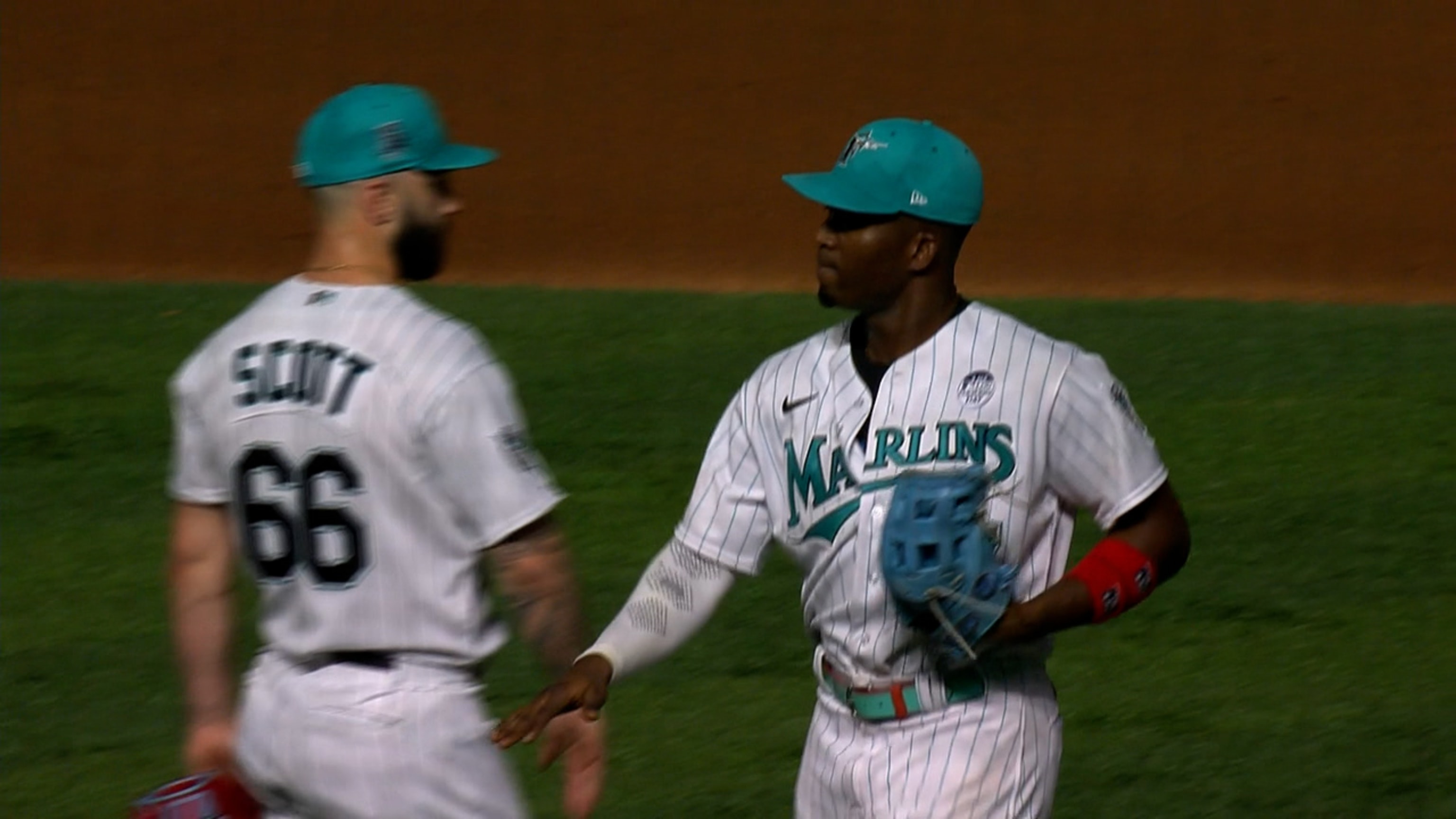 Miami Marlins' Jesus Sanchez, left, is congratulated by first base