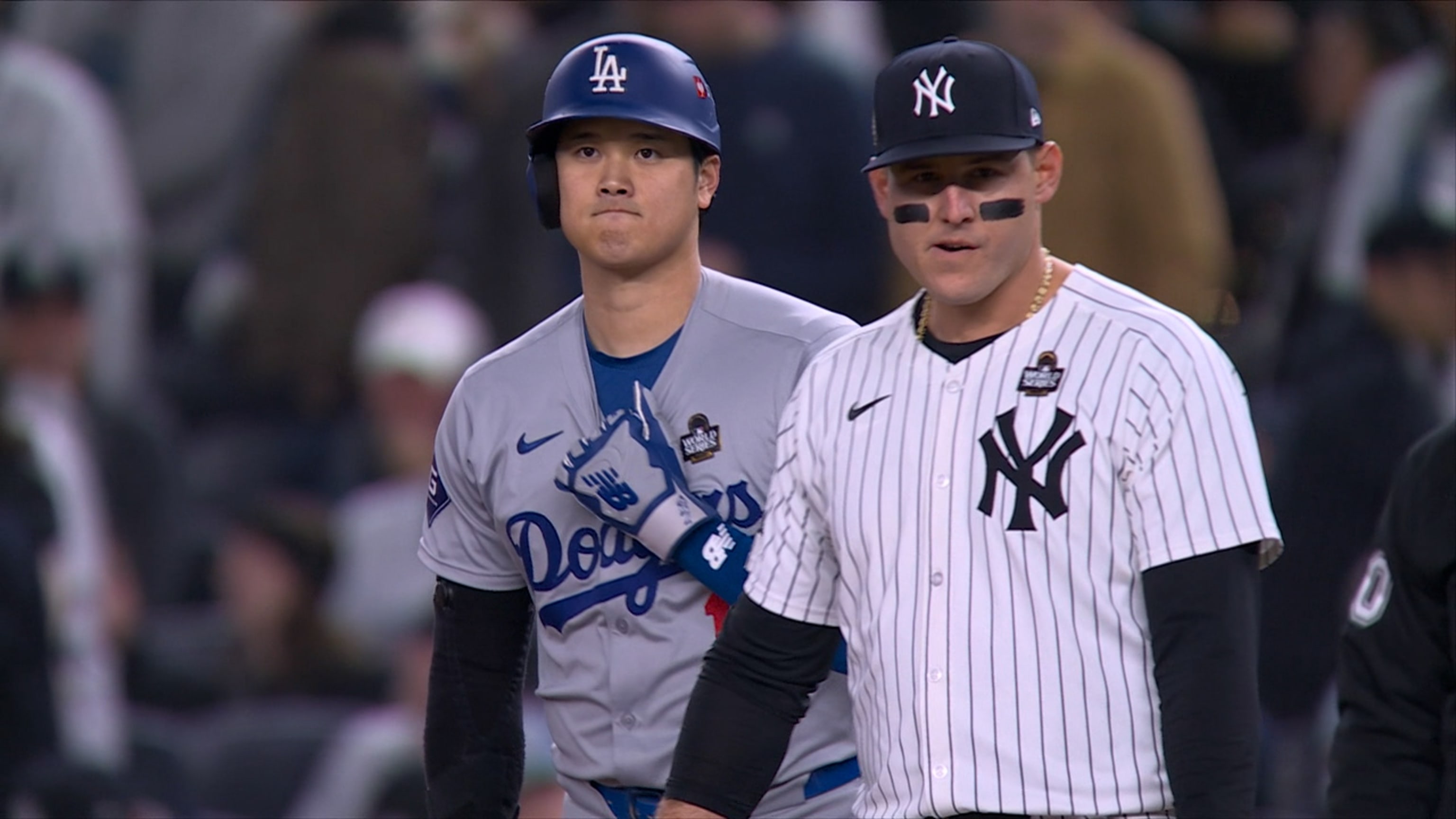 Shohei Ohtani walks, clutches his arm