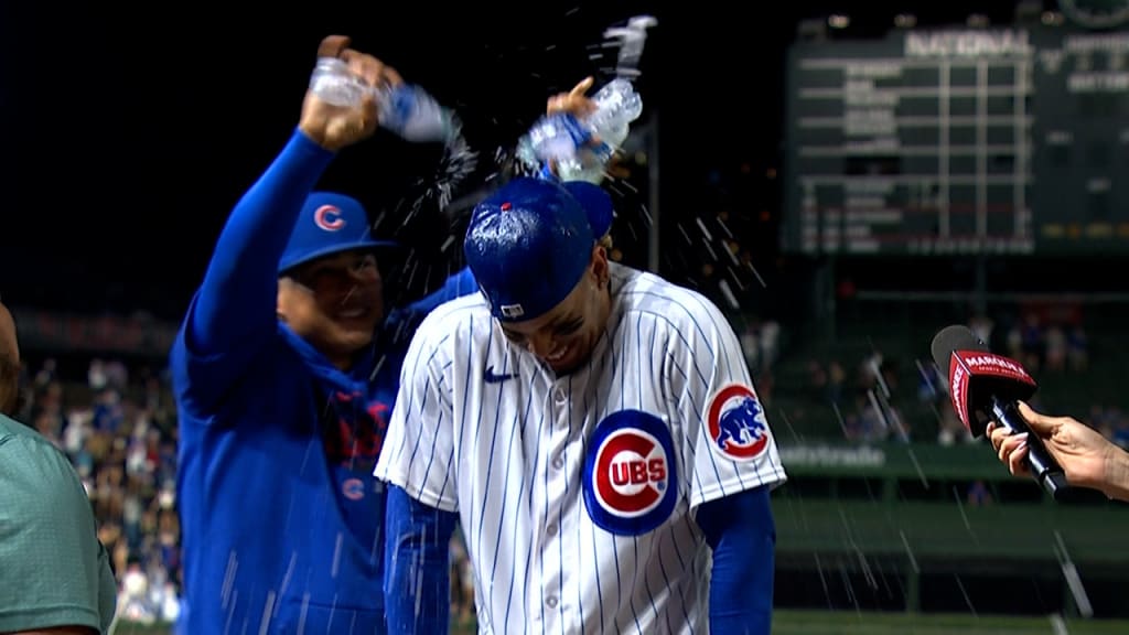 Cubs fan behind one-liner shirts