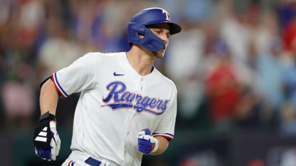 Adolis Garcia of the Texas Rangers fields a ball during the first