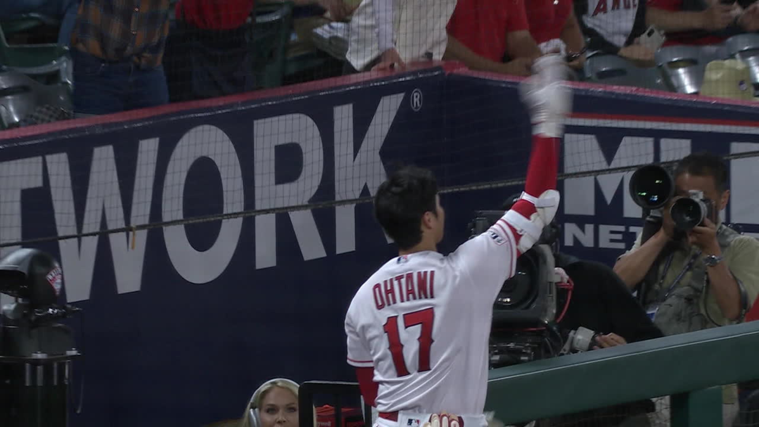 Los Angeles Angels' Shohei Ohtani runs his fingers through his hair during  the first inning of a baseball game against the Chicago Cubs Thursday, June  8, 2023, in Anaheim, Calif. (AP Photo/Mark