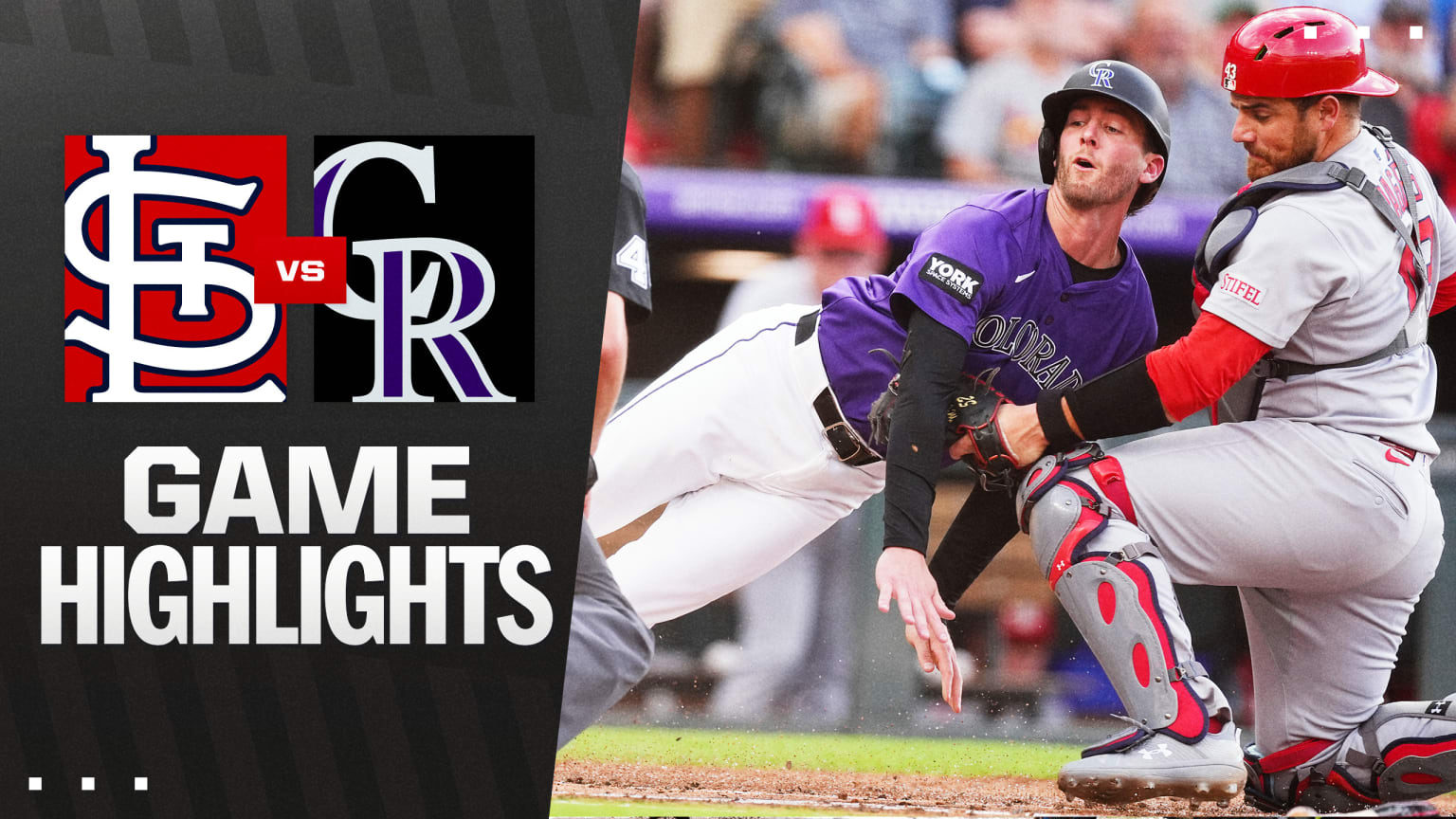 Action shot from the Cardinals versus Rockies game showing players on the field at Coors Field