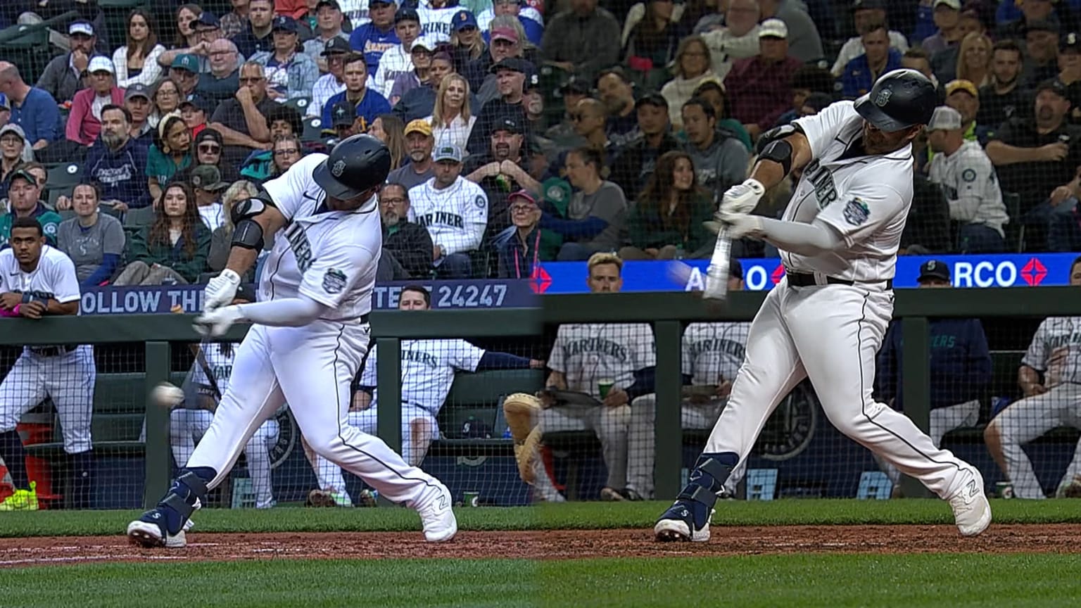 Seattle Mariners' Mike Ford walks through the dugout with a