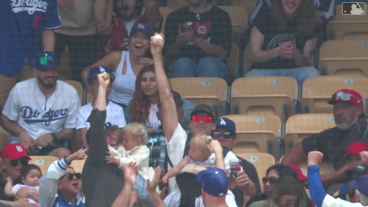 Baby-wearing, beverage-holding man catches foul ball with bare