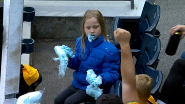 Young fan devours blue cotton candy