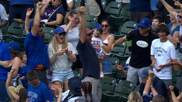 Fan catches foul ball while protecting a child 