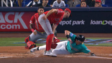 Kyle Stowers scores on a wild pitch after review