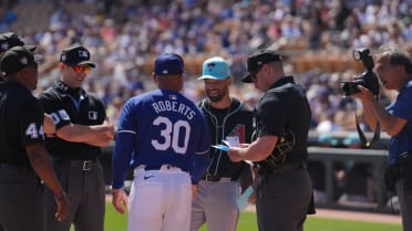 Dave and Cole Roberts exchange lineup cards 