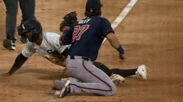 Luisangel Acuña safe stealing third base after review