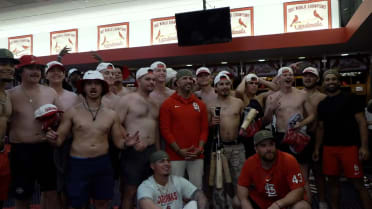 "Tarps Off" fans celebrate in the Cardinals clubhouse