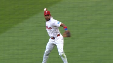 Edmundo Sosa slides, spins, throws to first base