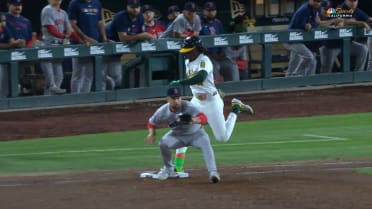 Lawrence Butler safe at first after challenge