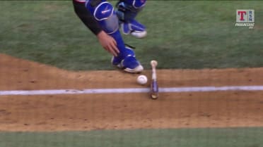 Kyle Higashioka fields bunt with help of bat
