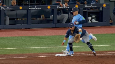 Daulton Varsho is safe at first after challenge
