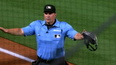 Seiya Suzuki is safe at first base after a review 