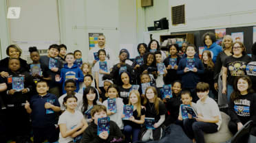 Micah Johnson reads his book at Minnie Miñoso Academy