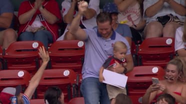 Fan makes one-handed catch with baby 