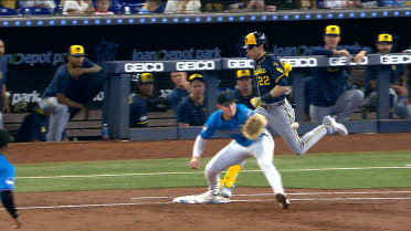 Christian Yelich hits an infield single after review