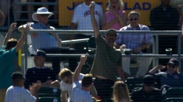 Fan catches a foul ball with a beer