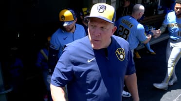 Pat Murphy eats a pancake given to him by a fan