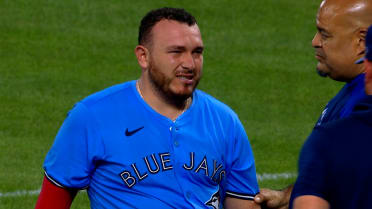 Alejandro Kirk leaves after being hit by a pitch