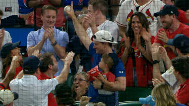 Cardinals' fan catches a foul ball while holding baby
